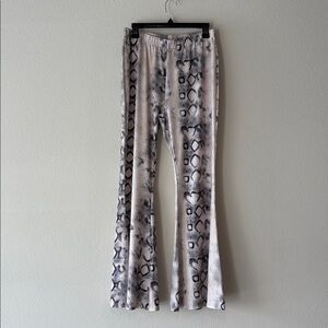 Snake Print Flared Pants In cream with black accents. Elastic waistband.